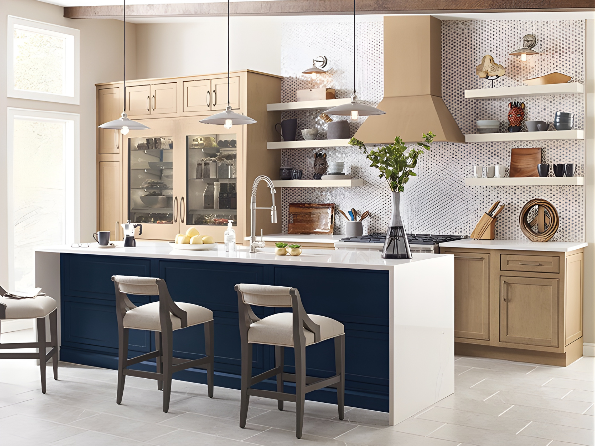 Coastal style kitchen remodel featuring a navy blue island, light wood cabinetry, pendant lighting, and white countertops in an Eastern Shore Maryland and Delaware home.