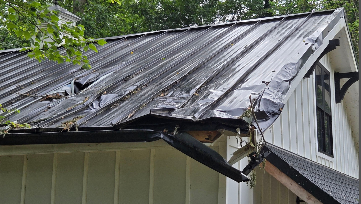 Storm-damaged roof on Eastern Shore home showing impact of coastal weather and wind exposure