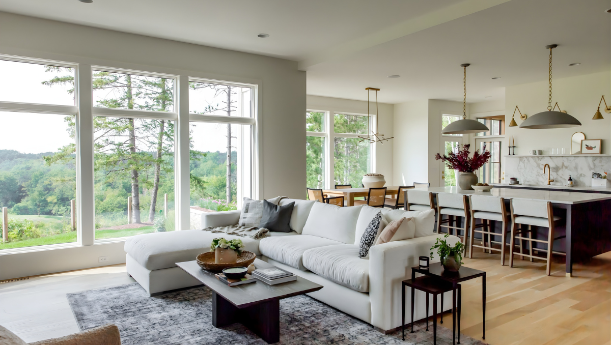 Open living room with large Andersen windows allowing natural light into a coastal home on Maryland’s Eastern Shore