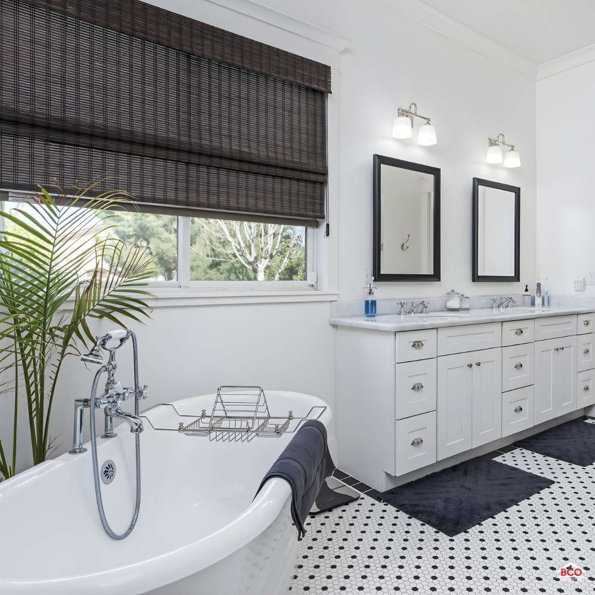 Bathroom remodeling Eastern Shore MD featuring a freestanding tub, double vanity, and bright natural light with window shades