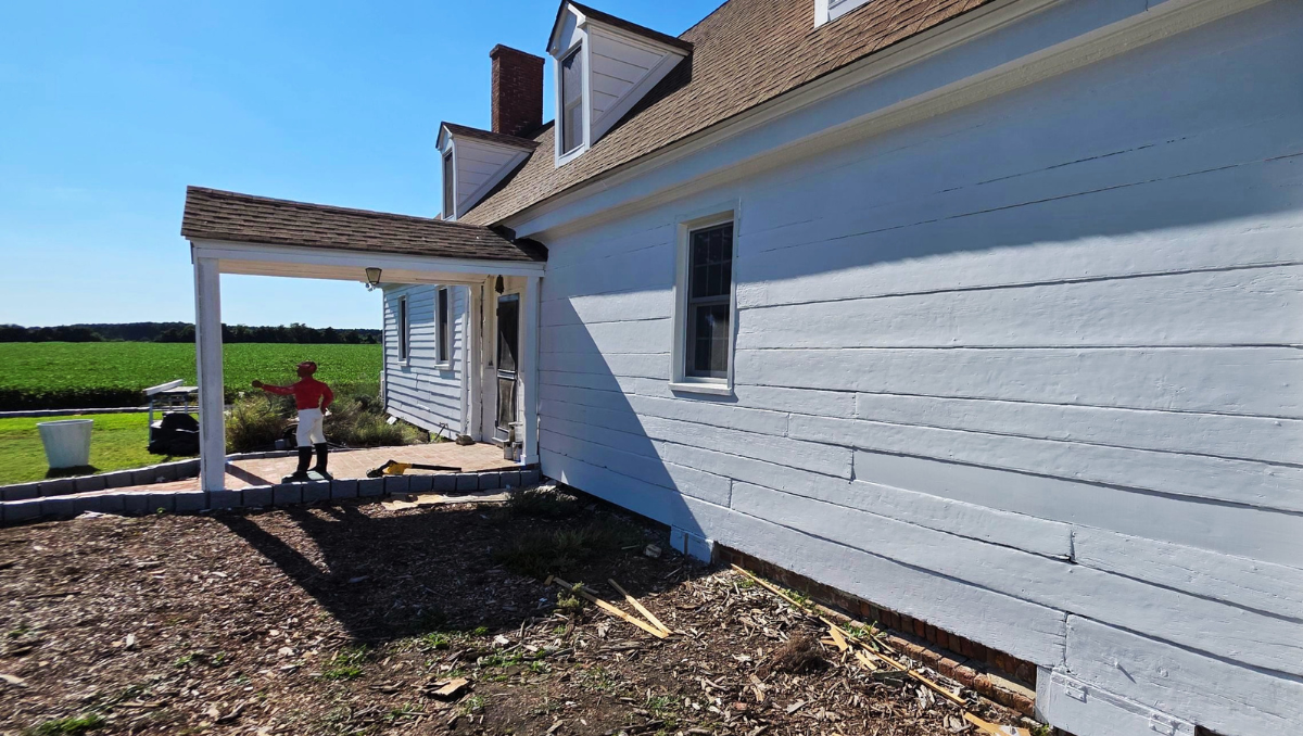 freshly painted with restored white weatherboard siding and original architectural details preserved