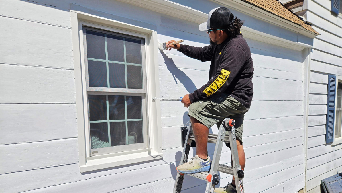 Contractor carefully painting exterior