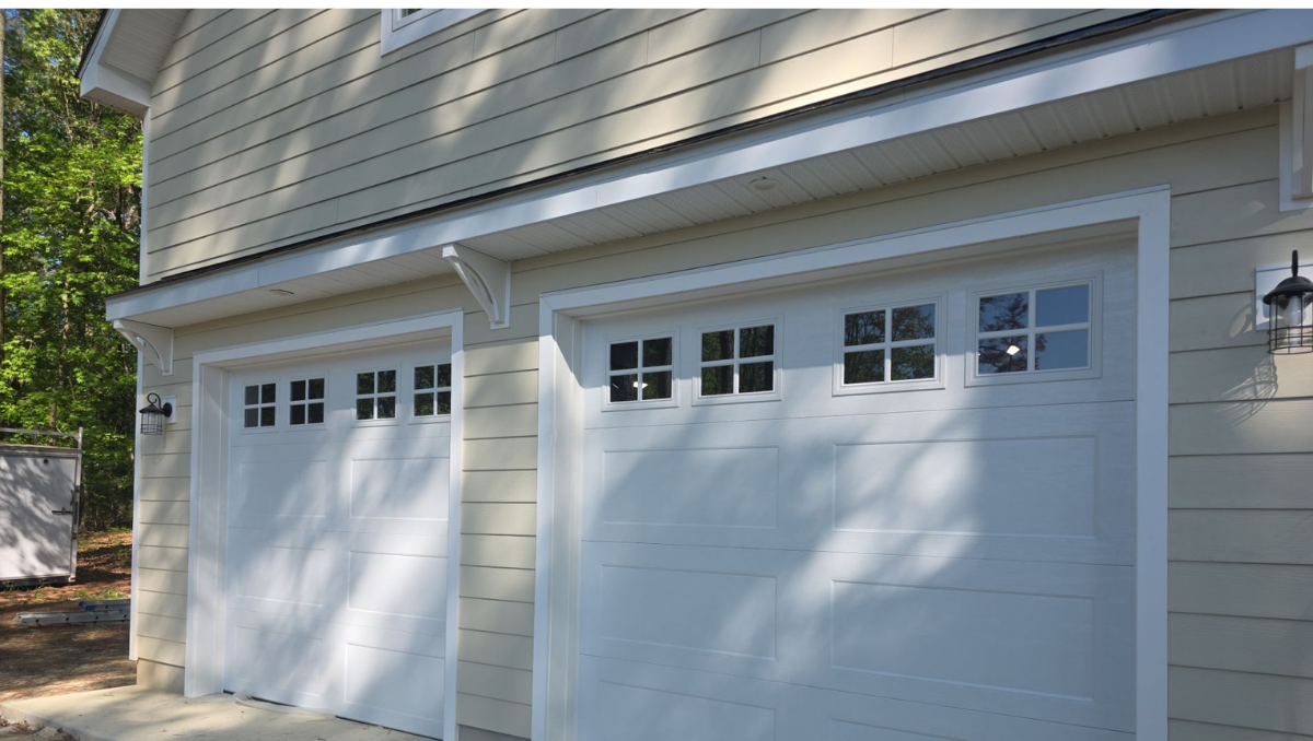 White carriage style garage doors installed on custom two car garage in Easton Maryland