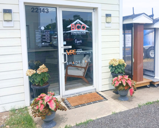 Entrance to the BCO Home & Outdoor Living Showroom in Denton, Maryland, featuring BCO Construction & Home Services, Vinyl Porch Enclosures, and Shade Sail Systems.