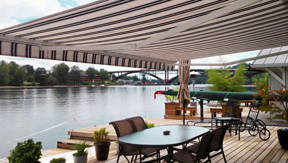 Large retractable awning extended over a waterfront deck, creating shade and comfort for outdoor dining and relaxation.