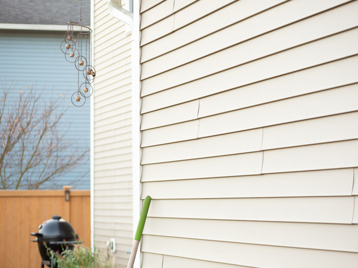 Damaged vinyl siding showing cracks during a fall home inspection on the Eastern Shore