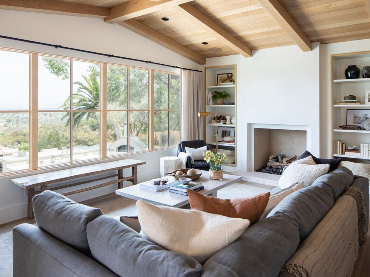 Bright living room with large energy-efficient windows providing natural light and comfort