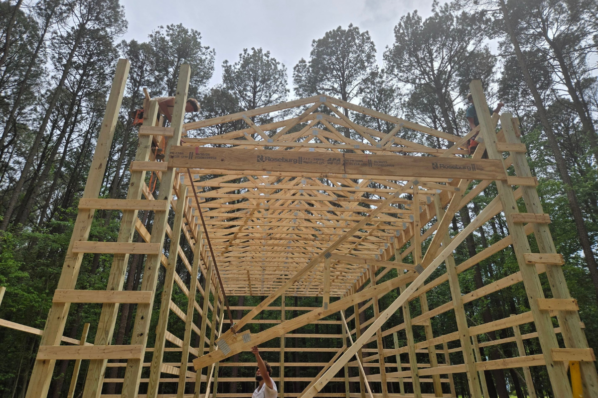 Amish crew installing roof trusses during a Tilghman Island pole barn construction project