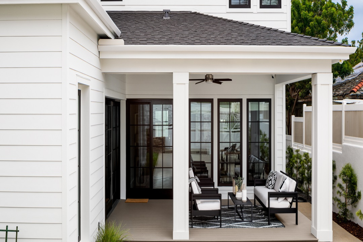 Black-framed windows and doors overlooking a covered patio