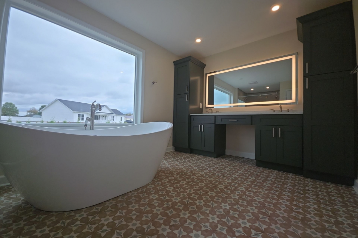 Custom double vanity with dark cabinetry and illuminated mirror in a converted garage bathroom